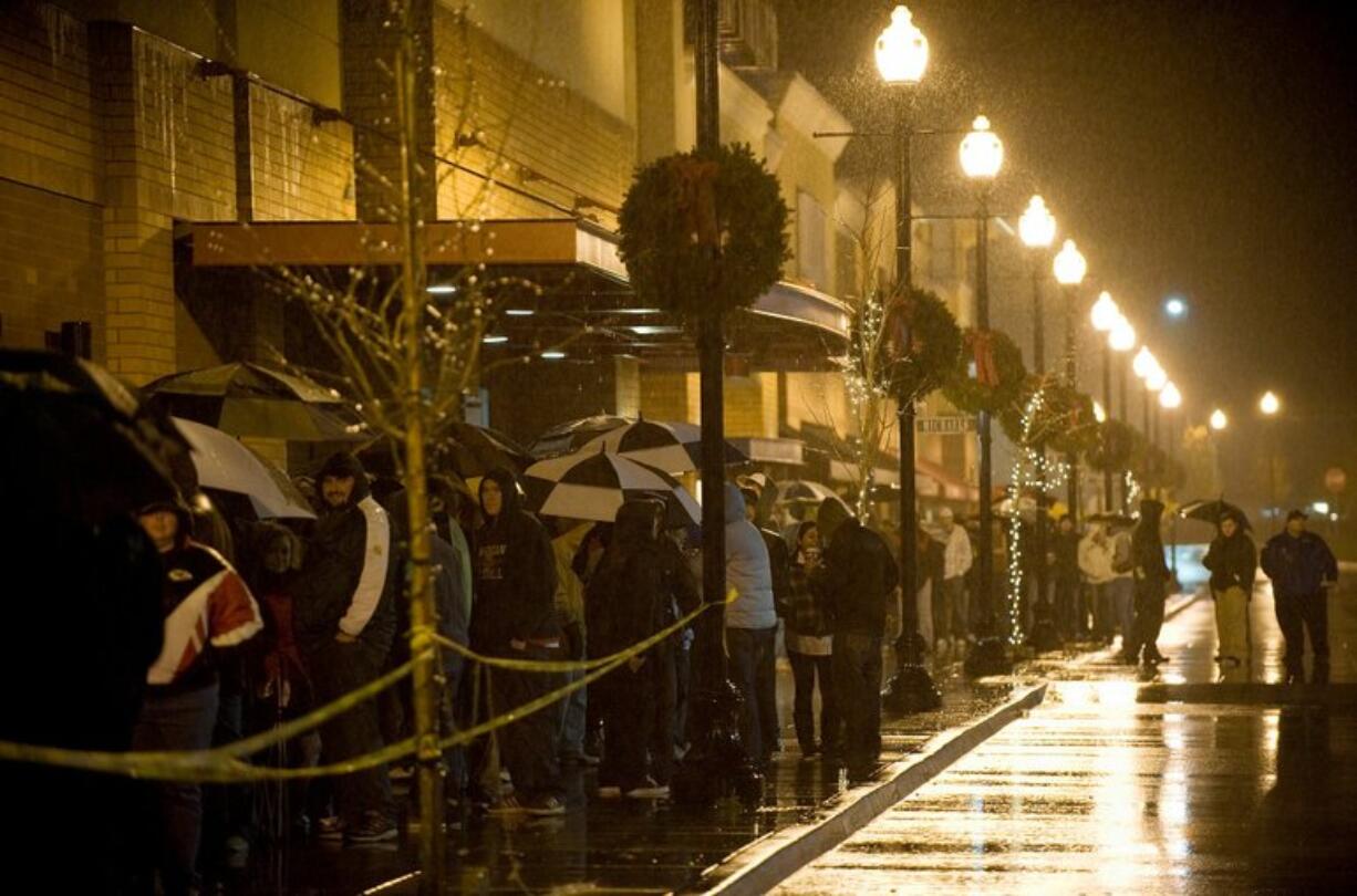 Steven Lane/The Columbian
Rain didn't deter bargain-hunters from waiting all night at Vancouver's Best Buy store. A stabilizing economy and shorter inventories may prevent the extreme discounting seen in 2008 as Christmas approaches.