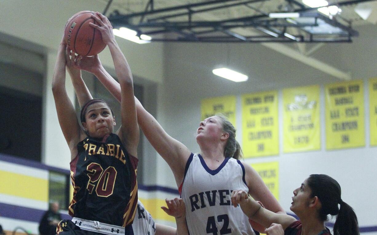 Cherita Daugherty of Prairie High School tries to score as Emma Fisk of Columbia River tries to thwart her attempt at a basketball game in Vancouver Tuesday.