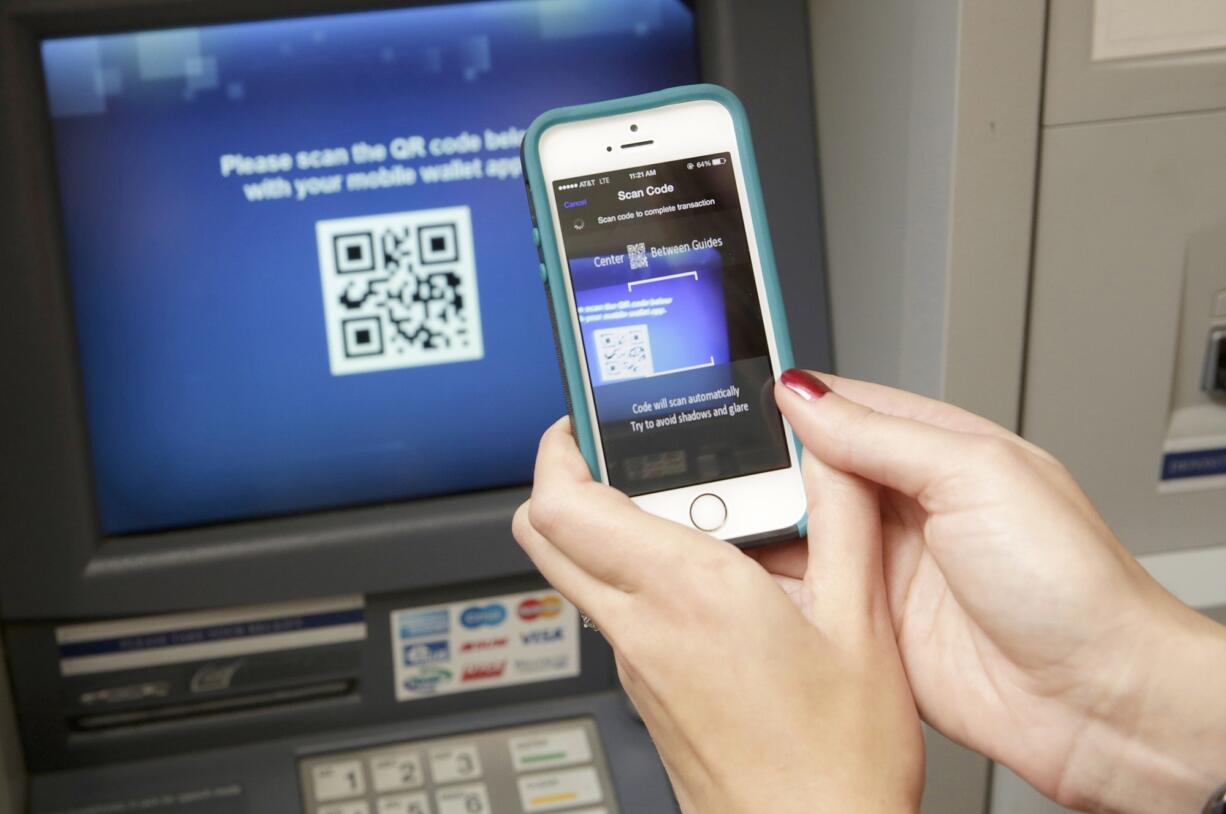 Kirsten Keary-Taylor, retail product specialist at Wintrust Financial, demonstrates Dec. 8 the use of the bank's cardless ATM machine.