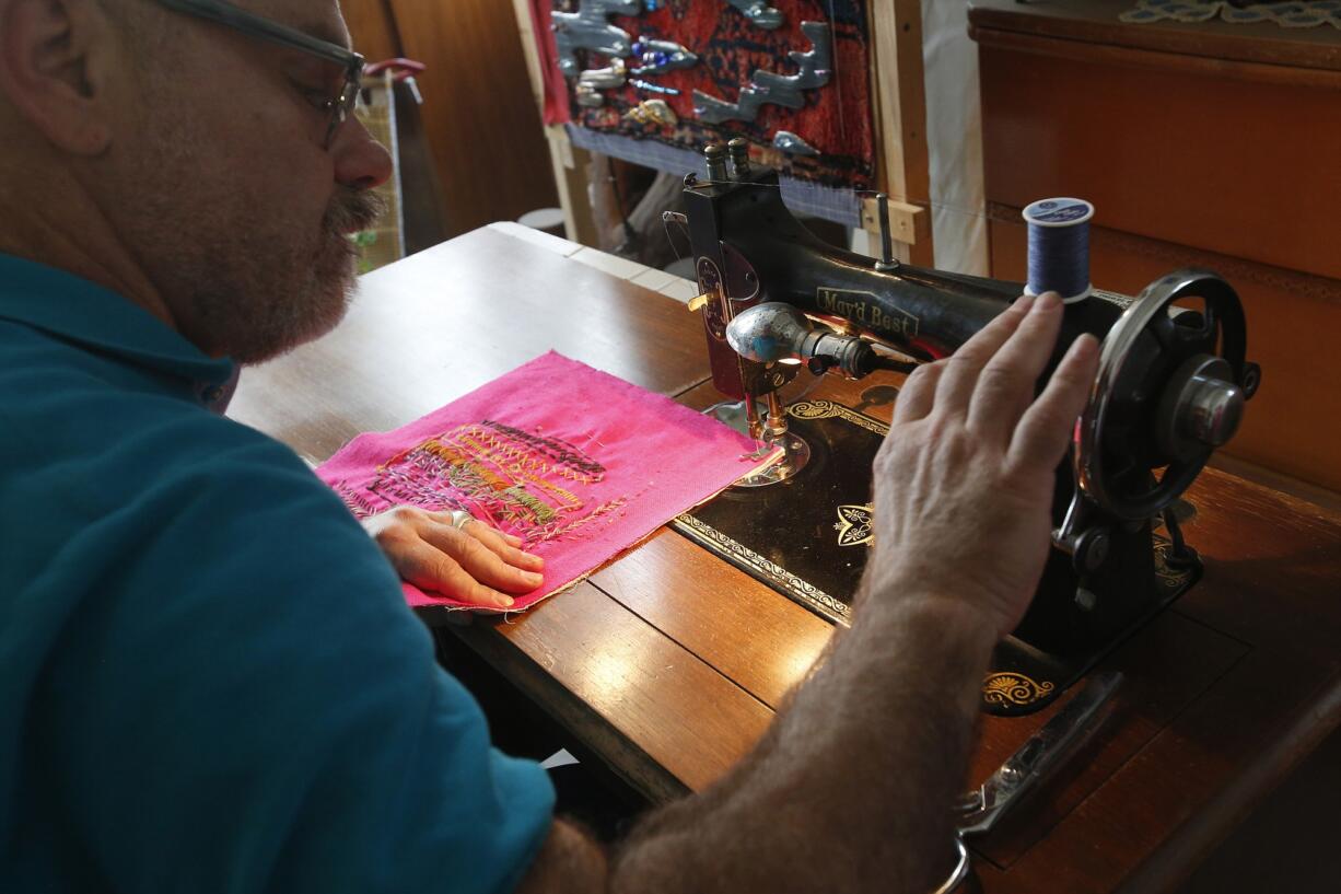 Joel Otterson sews quilt pieces together with his vintage sewing machine.