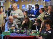 Guests follow the game Sunday at the Bernhardt Super Bowl party in Vancouver.