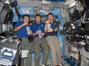 NASA/The Associated Press
Astronaut Mike Barratt of Camas, right, shares a toast with Koichi Wakata, left, and Gennady Padalka (a globe of water is floating in front of his chin) in a photo taken on May 20, 2009, to celebrate the space station's new water-recycling system.