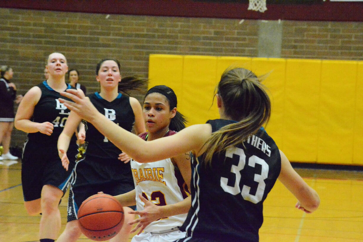 Prairie's Cherita Daugherty drives against a Bonney Lake defender during the second quarter of a bi-district playoff game Wednesday at Prairie.