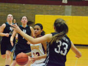 Prairie's Cherita Daugherty drives against a Bonney Lake defender during the second quarter of a bi-district playoff game Wednesday at Prairie.