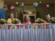 Seated from left, Esther Friberg, Wilma Zillman and Dolly Anders are the guests of honor Sunday during a birthday celebration at the Cascade Inn retirement home in Vancouver.