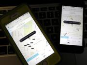 Associated Press files
The Uber app is displayed on smartphones.