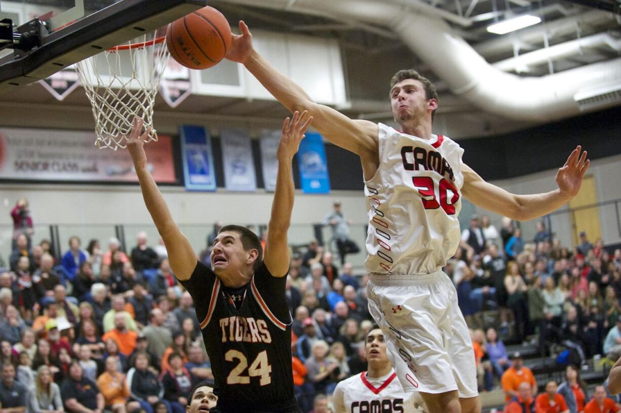 Camas' Trevor Jasinsky blocks a shot by Battle Ground's Andrej Besara at the 4A Boys District Tournament, Friday, February 20, 2015.