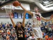 Camas' Trevor Jasinsky blocks a shot by Battle Ground's Andrej Besara at the 4A Boys District Tournament, Friday, February 20, 2015.