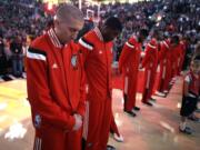 Portland's Steve Blake, left, is joined by his teammates for 25 seconds of silence in memory of former Trail Blazers Jerome Jersey, who passed away suddenly last week at the age of 52.