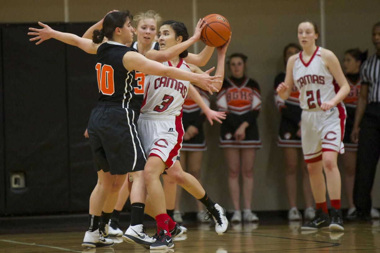 Camas' Brenna Khaw is trapped by the battle Ground defense. Camas beats Battle Ground at the 4A Girls District Tournament, Friday, February 20, 2015.