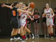 Camas' Brenna Khaw is trapped by the battle Ground defense. Camas beats Battle Ground at the 4A Girls District Tournament, Friday, February 20, 2015.