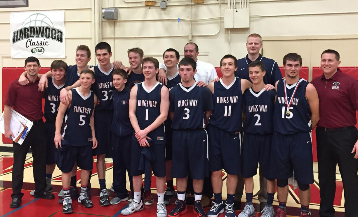 The King's Way Christian boys basketball team poses on the court after beating Seattle Academy 54-51 in overtime in the Class 1A state playoffs on Saturday.