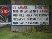 A sign outside the Clark Rifles shooting range warns about noise coming from the range.