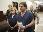 Sandra and Jeffrey Weller enter Judge Barbara Johnson's courtroom for sentencing in Clark County Superior Court March 20, 2013. The Wellers were convicted of imprisoning, starving and beating their adopted twins.