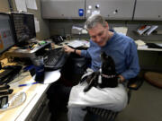 Dale Fite, president and &quot;watch dog&quot; of Tyler 2 Construction, watches over Sadie, a Chiweenie, in his office.