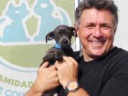 Finding Rover founder John Polimeno holds Ringo, who was the subject in a demonstration of his pet-finding app.