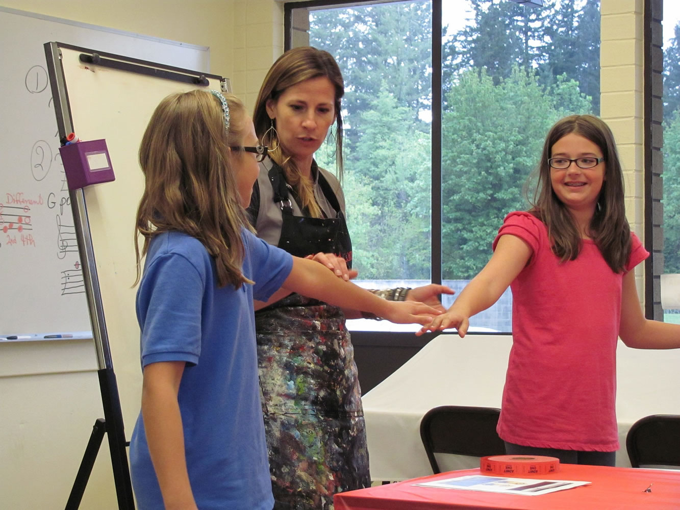 Stef Valent-Musleh, left, and Kelsey Osmus, right, determine if the minions will have one or two eyes by using &quot;Rock, Paper, Scissors.&quot;