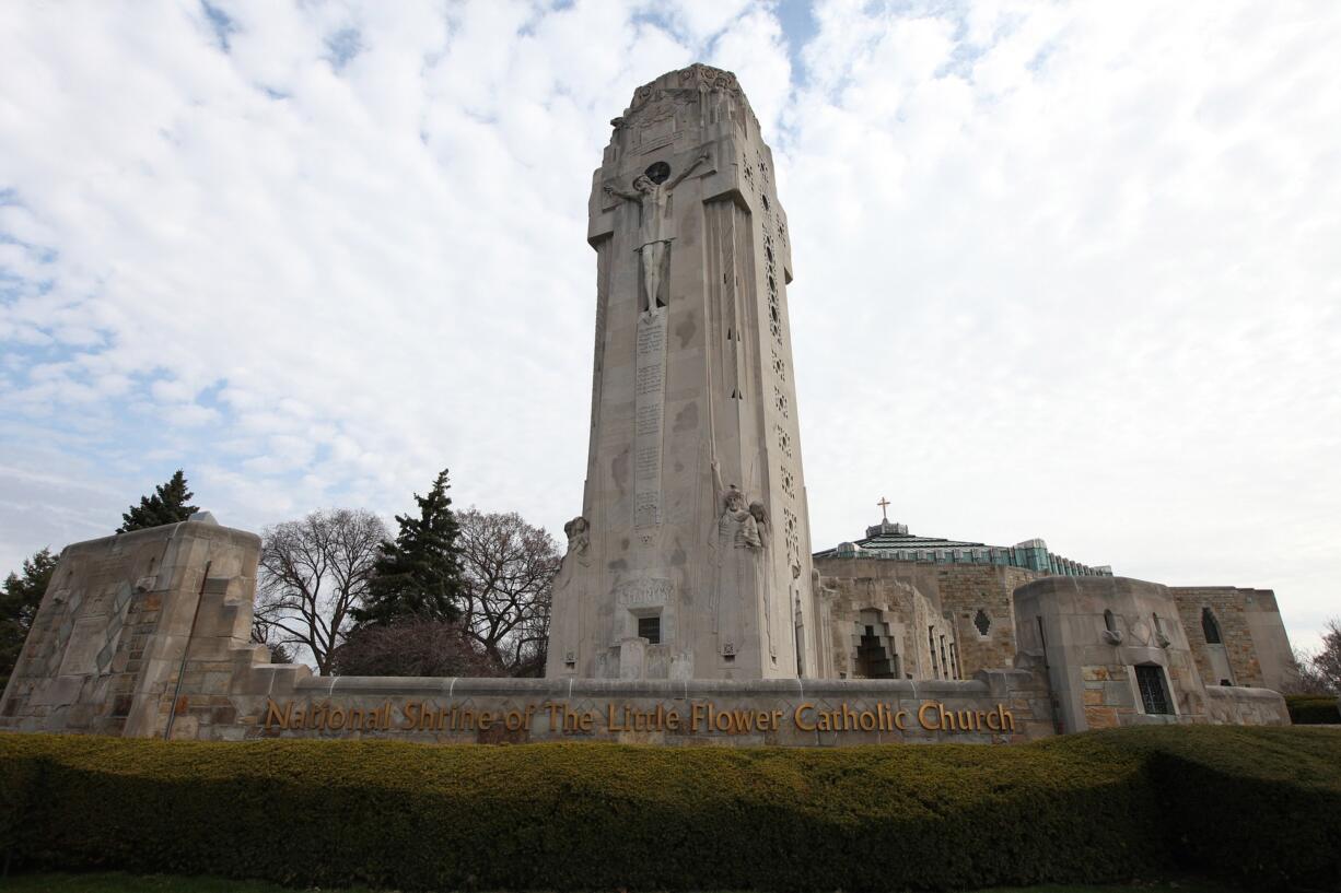 Limestone Art Deco tower called the Charity Crucifixion Tower, completed in 1931, features integrated figural sculptures by Rene Paul Chambellan, including a large figure of Christ on the cross, 28 feet (8.5 meters) high on the Woodward Avenue facade. Built in response to the Ku Klux Klan as a &quot;cross they could not burn&quot; at the National Shrine of the Little Flower Roman Catholic Church in Royal Oak, Mich. (Jessica J.