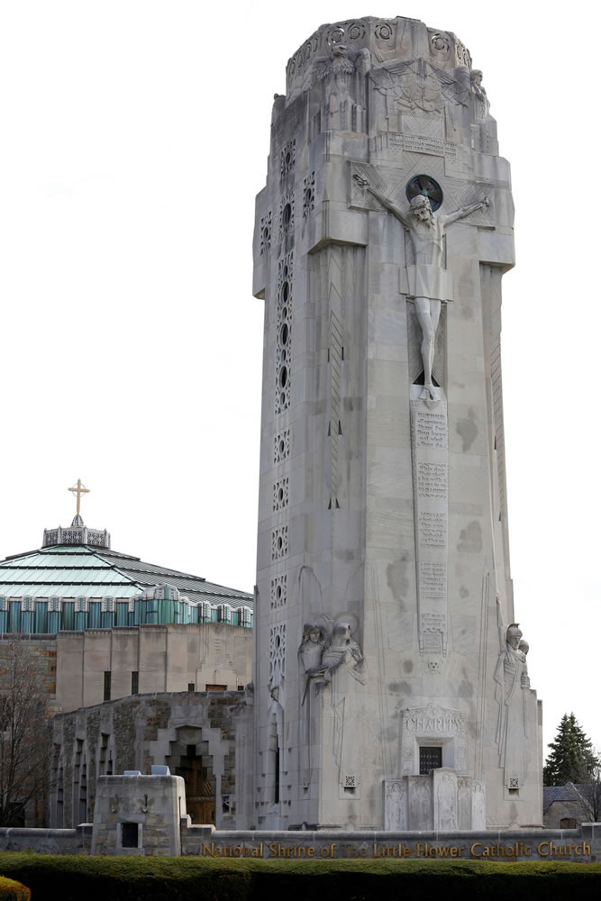 Limestone Art Deco tower called the Charity Crucifixion Tower, completed in 1931, features integrated figural sculptures by Rene Paul Chambellan, including a large figure of Christ on the cross, 28 feet (8.5 meters) high on the Woodward Avenue facade. Built in response to the Ku Klux Klan as a &quot;cross they could not burn&quot; at the National Shrine of the Little Flower Roman Catholic Church in Royal Oak, Mich. (Jessica J.