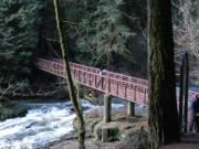 Lacamas Lake Regional Park visitors access the footbridge across Lower Falls on Lacamas Creek in this 2012 photo.