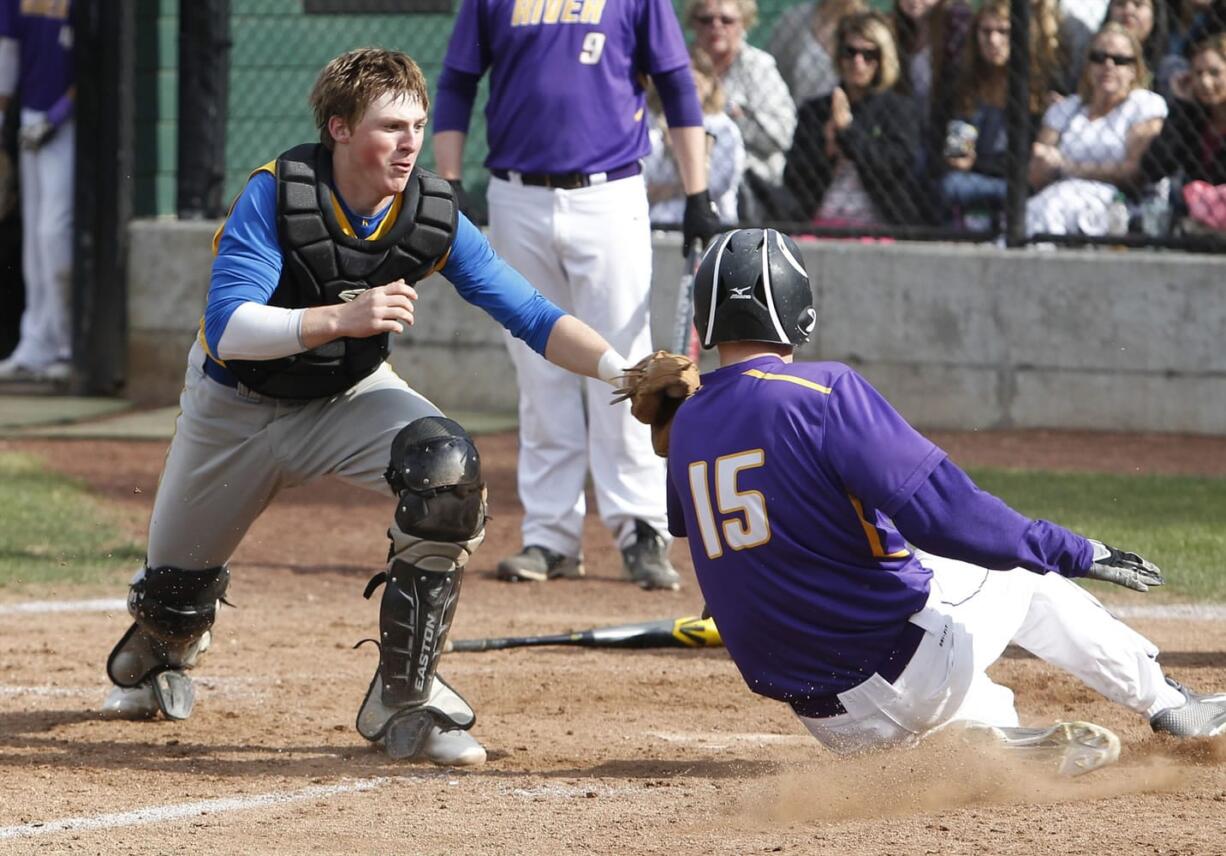 Kelso catcher Zak Schueller tags out Columbia River runner Tyler Hellman at home on Monday, May 4.