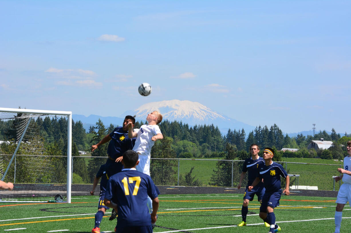 Ridgefield's Max Hauser (4) rises for a header in a 2A district boys soccer match against Aberdeen on Saturday, May 9, 2015, in Ridgefield.