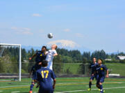 Ridgefield's Max Hauser (4) rises for a header in a 2A district boys soccer match against Aberdeen on Saturday, May 9, 2015, in Ridgefield.