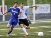 Mountain View player Abdul el-Hoot vies with Camas's Bennett Lehner during a 4A district boys soccer playoff match in Camas on Tuesday.