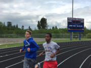 Ridgefield sophomore Silas Griffith, right, runs with teammate Ciarnin McNeil during a recent track practice.