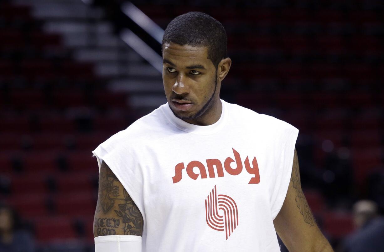 Portland Trail Blazers forward LaMarcus Aldridge wears a warmup shirt in memory of season ticket holder Sandra Zickefoose before a game on Sunday, Nov.