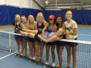 Skyview teammates hold up senior Sammi Hampton on the net on Saturday at the Columbia Basin Racquet Club in Richland after Hampton was declared the Class 4A singles champion for a fourth year in a row.