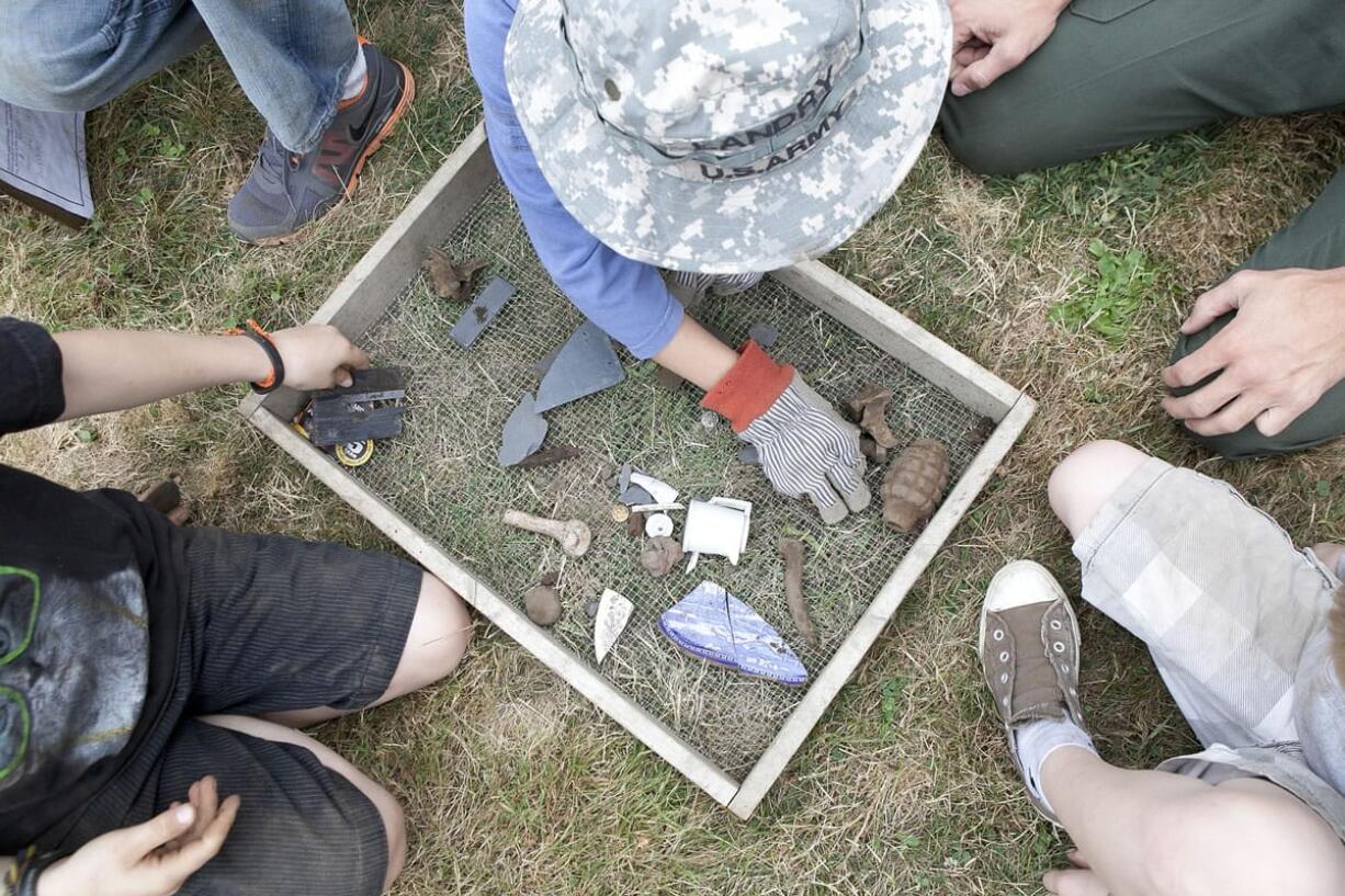 A group of kids took turns digging and sifting dirt as they participated in a mock archaeology at Fort Vancouver, Saturday morning.