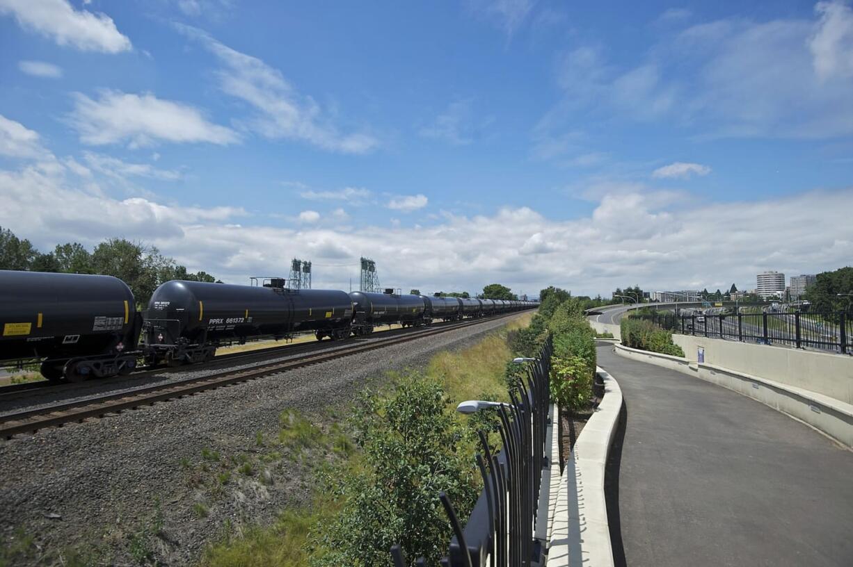 An oil train passes the Vancouver Land Bridge in  June 2014.