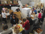 Columbian files
Volunteers box donations at the Clark County Food Bank after the 2014 National Association of Letter Carriers Food Drive. The Food Bank is looking to expand its warehouse.