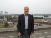 Barry Cain of Gramor Development poses for a photo on roof of city hall in Vancouver Thursday October 9, 2014. The area in the background will be the site of a $1.3 billion commercial/residential redevelopment of the city?s waterfront.