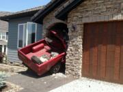 A red Nissan pickup crashed into the front door of a house in Camas's Prune Hill neighborhood.