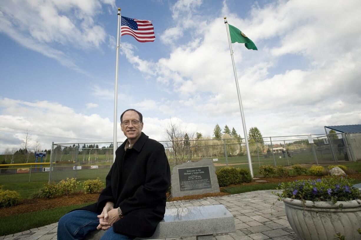 La Center Mayor Jim Irish sits at a memorial for Michael J. Nolan built at the city's baseball fields four years ago.