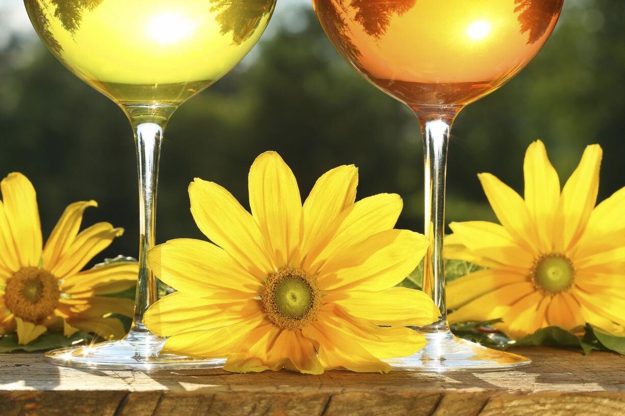 Golden wine in the sun on rustic table