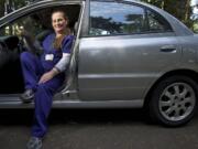 Jenny Rund, an itinerant Certified Nursing Assistant and personal caregiver, shows off her shiny new-to-her Kia Rio.