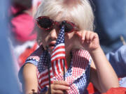 Wearing red, white and blue and waving a small American flag, Cassandra Knobeloch prepares for the July 4th Felida Children's Parade in 2003.