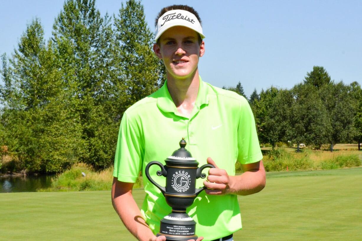 Spencer Tibbits of Fort Vancouver High School, poses with the champions trophy after winning the Oregon Junior Stroke Play Championship on Thursday, July 2, 2015, at OGA Golf Course in Woodburn, Ore.