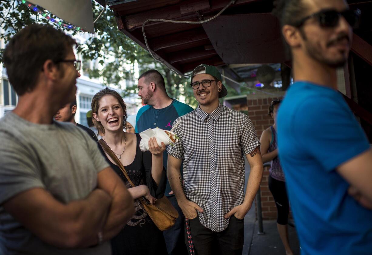 Customers wait in line for Egyptian food at a cart in Portland.