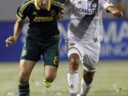 Portland Timbers midfielder Diego Valeri, left, battles Los Angeles Galaxy midfielder Baggio Husidic for the ball during the first half of an MLS soccer game in Carson, Calif., Wednesday, June 24, 2015.