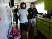 A warrant is served at the home of Adam Alexander, owner of Grow Systems Northwest, onThursday.