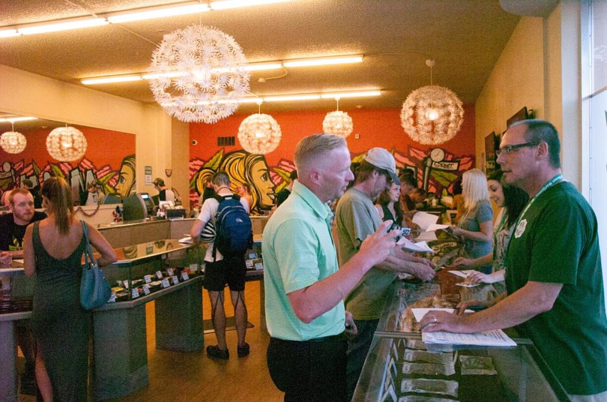 Justin Runquist/The Columbian
Customers visit Vancouver recreational pot shop Main Street Marijuana on July 1, the day recreational marijuana became legal in Oregon.