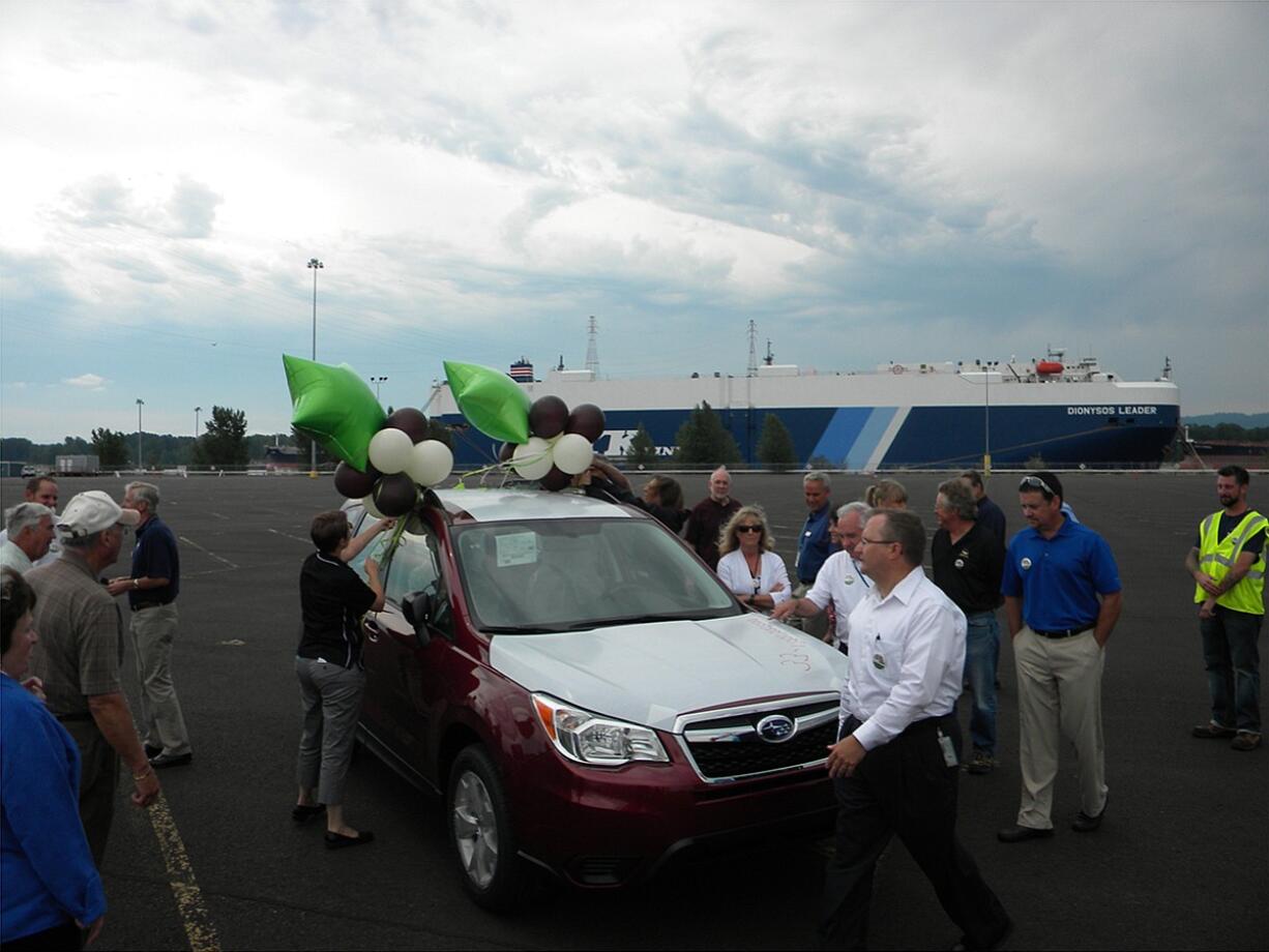 Guests admire the one-millionth Subaru imported at the Port of Vancouver. Last year, 69,378 came across the dock here.