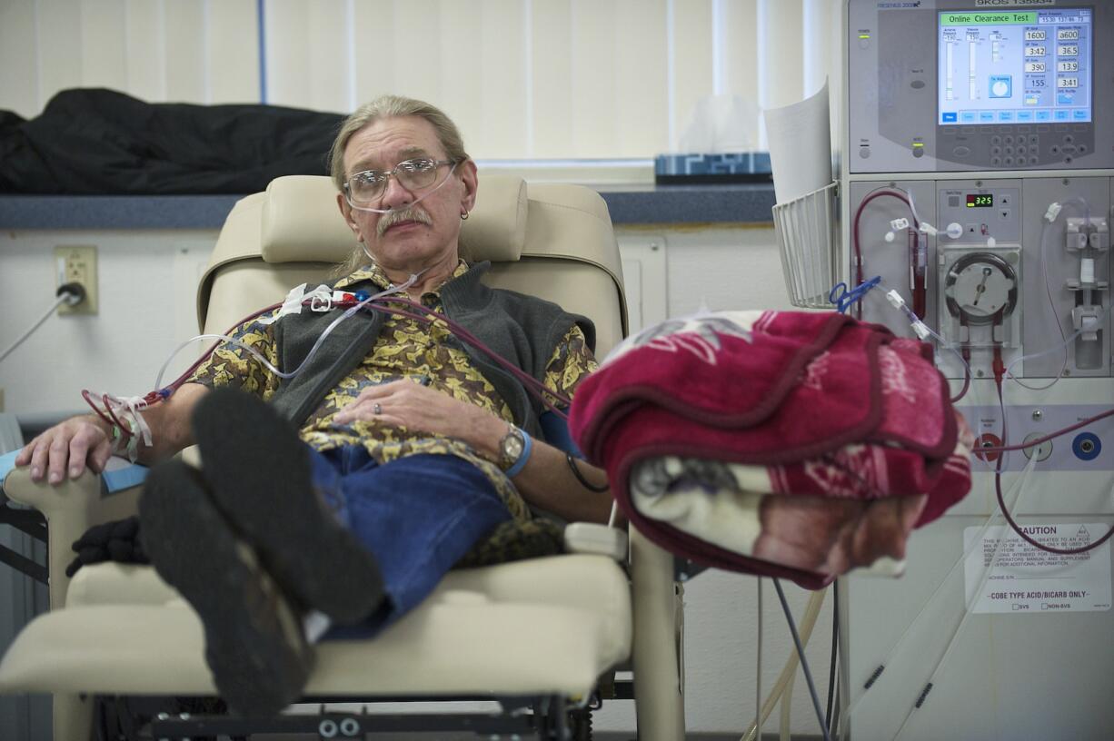 Larry Sperry watches television to help pass the four hours it takes to receive dialysis at the Fresenius facility in Salmon Creek in January 2013.