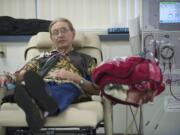 Larry Sperry watches television to help pass the four hours it takes to receive dialysis at the Fresenius facility in Salmon Creek in January 2013.