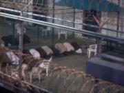 War-on-terror captives from two different cellblocks, separated by a fence, conduct communal evening prayers at the Camp 6 prison building for cooperative captives at the U.S. Navy Base at Guantanamo Bay, Cuba, on July 7. This photo was taken through a closed window. U.S.