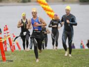 Participants leave the Columbia River following the half-mile swim portion of the Girlfriends and Dudes Triathlon on Sunday at Frenchman's Bar Park. Next was a 12.5-mile bike ride, and then a 3-mile run.